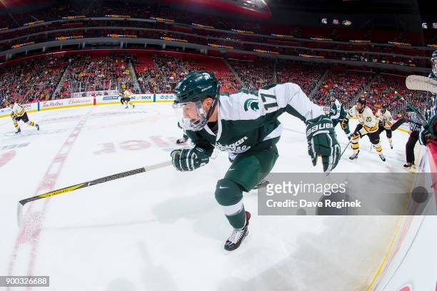 Taro Hirose of the Michigan State Spartans skates up ice against the Michigan Tech Huskies during game one of the Great Lakes Invitational Hockey...