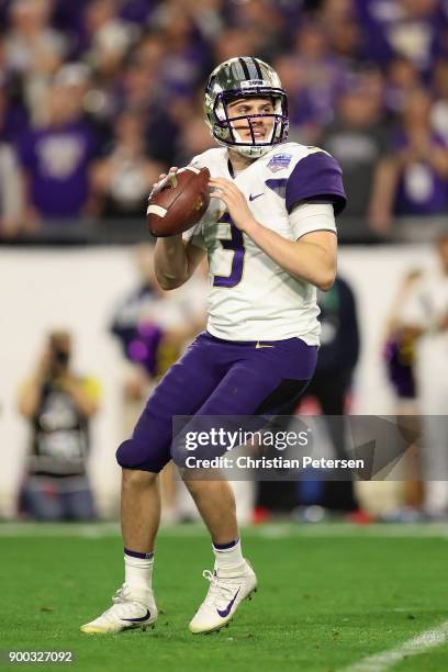 Quarterback Jake Browning of the Washington Huskies drops back to pass during the second half of the Playstation Fiesta Bowl against the Penn State...