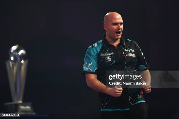 Rob Cross of England celebrates winning the first set during the final match against Phil Taylor of England on Day Fifteen at the 2018 William Hill...
