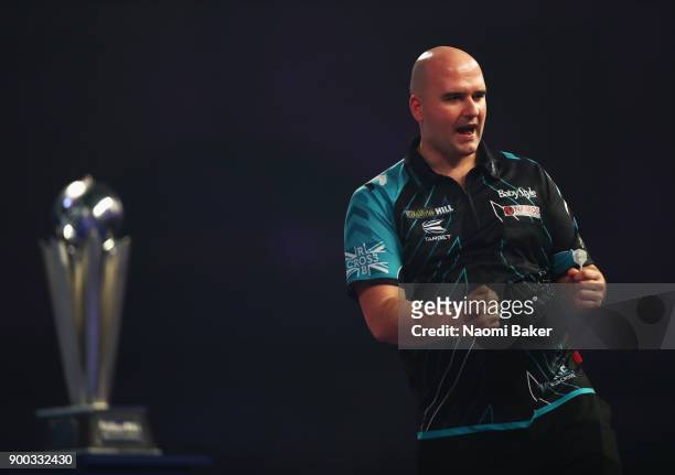 Rob Cross of England celebrates winning the first set during the final match against Phil Taylor of England on Day Fifteen at the 2018 William Hill...