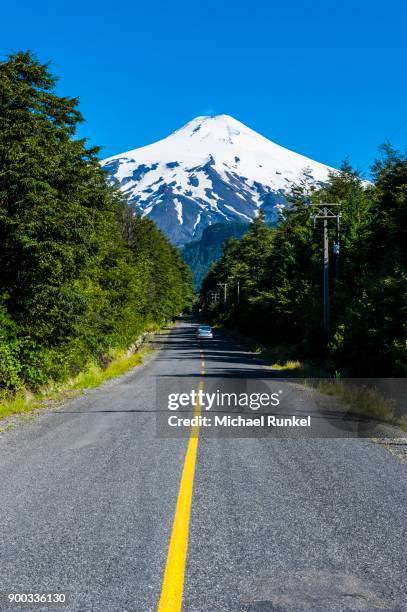 road leading to the snowcapped volcano villarrica, pucon, southern chile, chile - pucon stockfoto's en -beelden