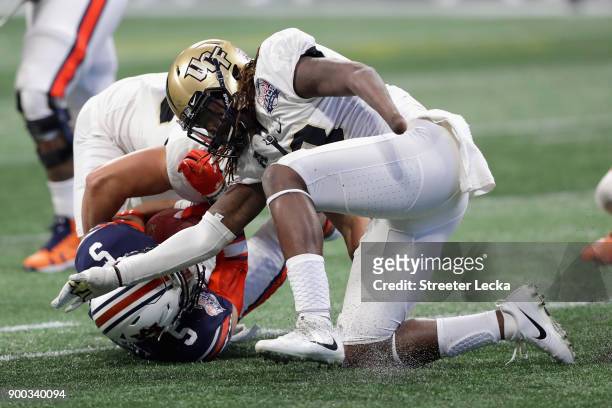 Shaquem Griffin of the UCF Knights sacks Jarrett Stidham of the Auburn Tigers in the third quarter during the Chick-fil-A Peach Bowl at Mercedes-Benz...