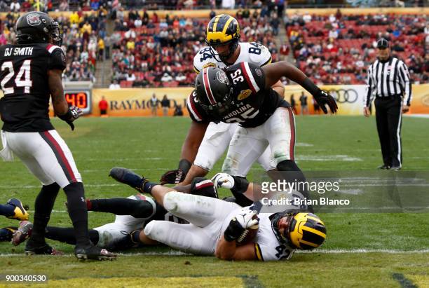 Fullback Ben Mason of the Michigan Wolverines falls into the end zone for the touchdown on a 1-yard run during the third quarter of the Outback Bowl...