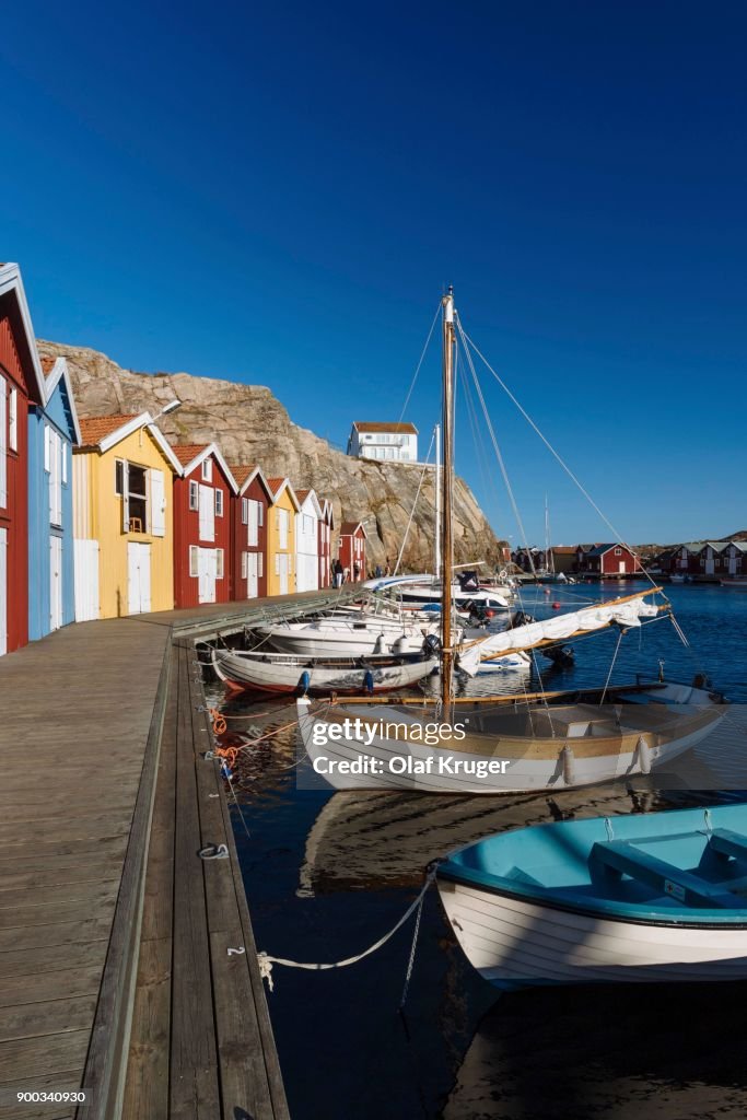 Boats and colourful boathouses in the harbour of Smoegen, Smoegenbryggan, Vaestra Goetalands Laen, Bohuslaen, Schwedena