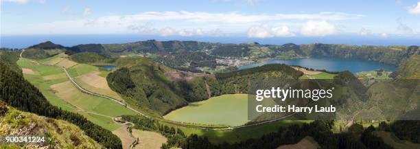 panorama, view of the volcanic crater caldeira das sete cidades, in front of the volcanic lake lagoa de santiago, in the back on the right the volcanic lake lagoa azul, island sao miguel, azores, portugal - cidades foto e immagini stock