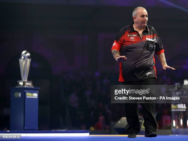 Phil Taylor reacting during day fifteen of the William Hill World Darts Championship at Alexandra Palace, London.