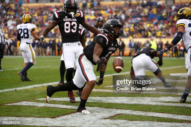 Running back Rico Dowdle of the South Carolina Gamecocks celebrates in the end zone following his touchdown during the third quarter of the Outback...