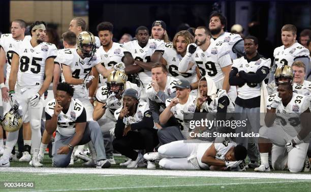 Players on the UCF Knights sideline react in the second half against the Auburn Tigers during the Chick-fil-A Peach Bowl at Mercedes-Benz Stadium on...