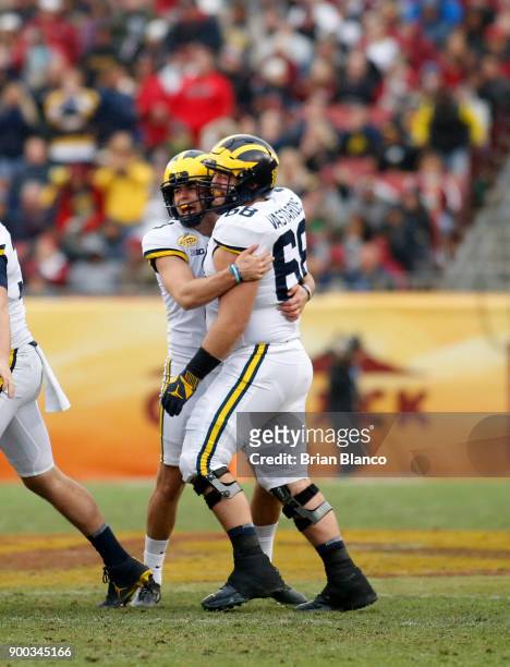 Place kicker Quinn Nordin of the Michigan Wolverines celebrates with offensive lineman Andrew Vastardis following his 48-yard field goal during the...