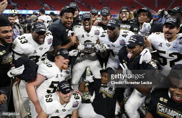 The UCF Knights celebrate defeating the Auburn Tigers 34-27 to win the Chick-fil-A Peach Bowl at Mercedes-Benz Stadium on January 1, 2018 in Atlanta,...