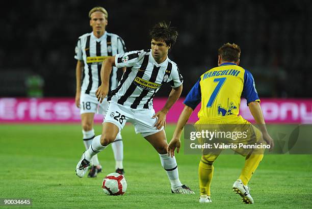 Ribas Da Cunha Diego of Juventus competes for the ball with Michele Marcolini of Chievo during the Serie A match between Juventus FC vs AC Chievo...