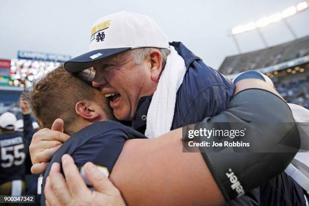 Head coach Brian Kelly of the Notre Dame Fighting Irish is lifted up by Hunter Bivin following the Citrus Bowl against the LSU Tigers on January 1,...