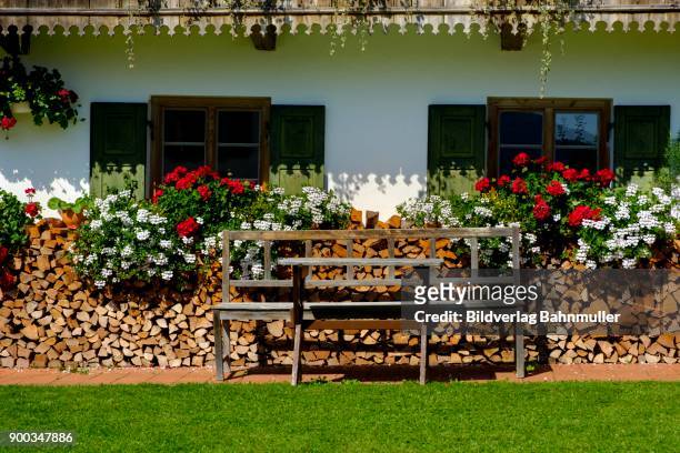flower decoration on a farmhouse, wackersberg, isarwinkel, upper bavaria, bavaria, germany - firewood stock-fotos und bilder