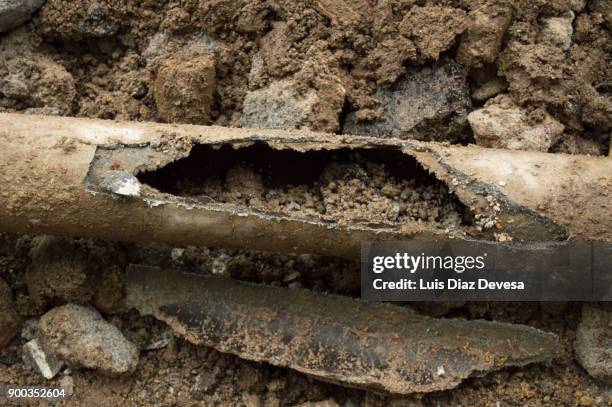 asbestos water pipeline damaged - asbestos stock pictures, royalty-free photos & images