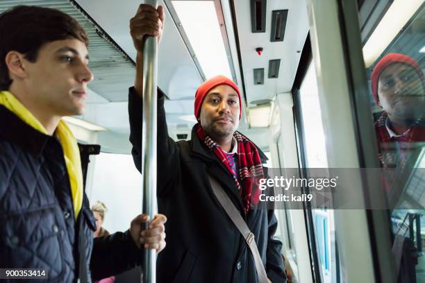 people riding train to work in winter - stranger stock pictures, royalty-free photos & images