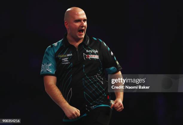 Rob Cross of England celebrates winning a set during the final match against Phil Taylor of England on Day Fifteen at the 2018 William Hill PDC World...