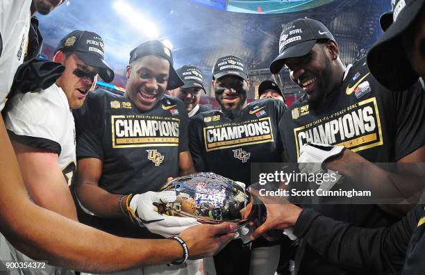 Members of the Central Florida Knights celebrate after the game against the Auburn Tigers during the Chick-fil-A Peach Bowl on January 1, 2018 in...