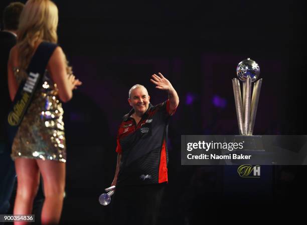 Phil Taylor of England shows appreciation to the crowd after he loses the PDC World Darts Championship final against Rob Cross of England on Day...