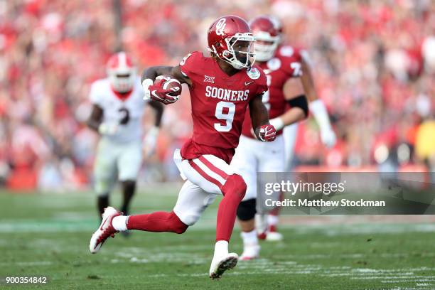 Wide receiver CeeDee Lamb of the Oklahoma Sooners runs after a catch against the Georgia Bulldogs in the first half in the 2018 College Football...