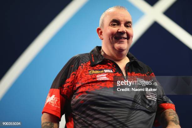 Phil Taylor of England poses for a photograph as he walks onto the stage prior to the Final against Rob Cross of England on Day Fifteen at the 2018...