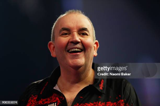 Phil Taylor of England reacts after winning a leg during the PDC World Darts Championship final against Rob Cross of England on Day Fifteen at the...