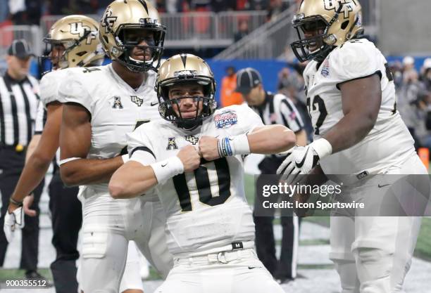 Golden Knights quarterback McKenzie Milton celebrates a touchdown during the Chick-fil-A Peach Bowl between the UCF Knights and the Auburn War Eagles...