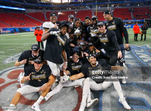 Knights hold the winners trophy after winning the Chick-fil-A Peach Bowl between the UCF Knights and the Auburn War Eagles on January 1, 2017 at...