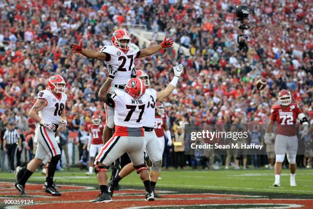 Nick Chubb of the Georgia Bulldogs and Isaiah Wynn of the Georgia Bulldogs celebrate after a 50 yard touchdown in the 2018 College Football Playoff...