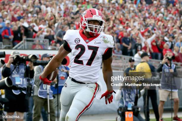 Nick Chubb of the Georgia Bulldogs celebrates after a 50-yard touchdown in the third quarter in the 2018 College Football Playoff Semifinal Game...