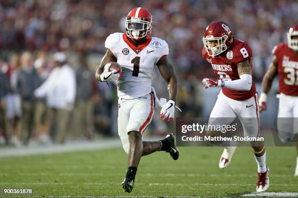 Running back Sony Michel of the Georgia Bulldogs scores on a 38-yard touchdown in the third quarter against the the Oklahoma Sooners in the 2018...