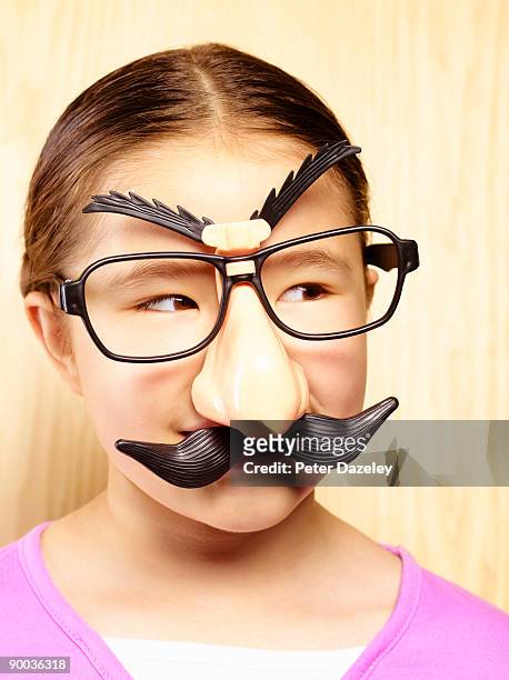 girl in groucho marx mask. - groucho marx disguise stock pictures, royalty-free photos & images