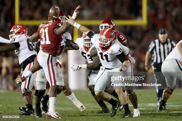 Quarterback Jake Fromm of the Georgia Bulldogs flips the ball and is called for intentional grounding in the second half against the Oklahoma Sooners...