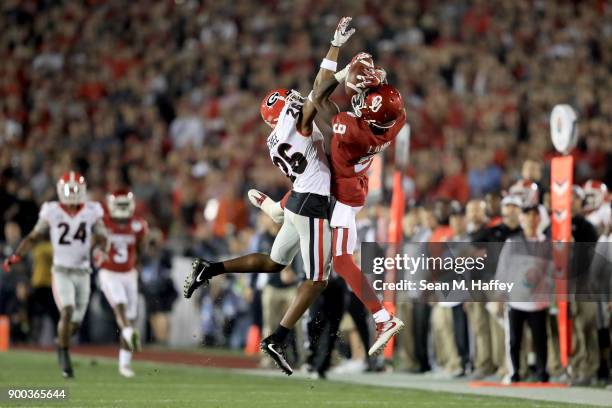 Wide receiver CeeDee Lamb of the Oklahoma Sooners makes a leaping 36-yard catch against defensive back Tyrique McGhee of the Georgia Bulldogs in the...