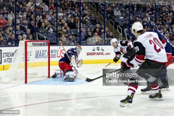 Arizona Coyotes right wing Christian Fischer has a shot deflected by Columbus Blue Jackets goalie Sergei Bobrovsky during the second period in a game...