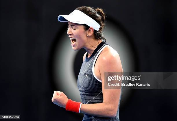 Garbine Muguruza of Spain celebrates after winning the first set in her match against Aleksandra Krunic of Serbia during day three of the 2018...