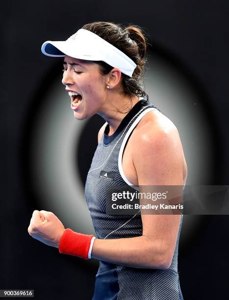 Garbine Muguruza of Spain celebrates after winning the first set in her match against Aleksandra Krunic of Serbia during day three of the 2018...