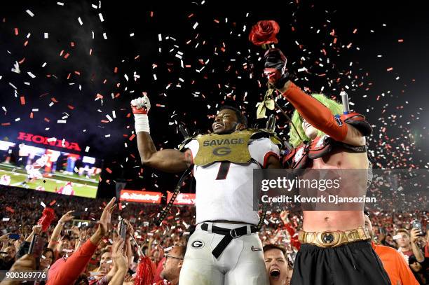 Linebacker Lorenzo Carter of the Georgia Bulldogs celebrates with a fan after winning the 2018 College Football Playoff Semifinal at the Rose Bowl...