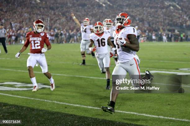 Sony Michel of the Georgia Bulldogs scores the winning touchdown in the 2018 College Football Playoff Semifinal Game against the Oklahoma Sooners at...