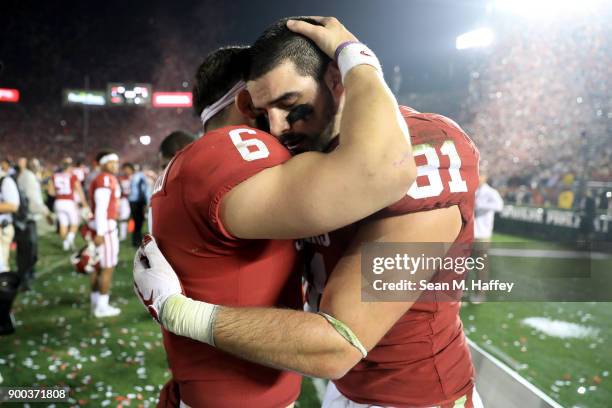 Baker Mayfield of the Oklahoma Sooners and Mark Andrews of the Oklahoma Sooners hug after the 2018 College Football Playoff Semifinal Game against...