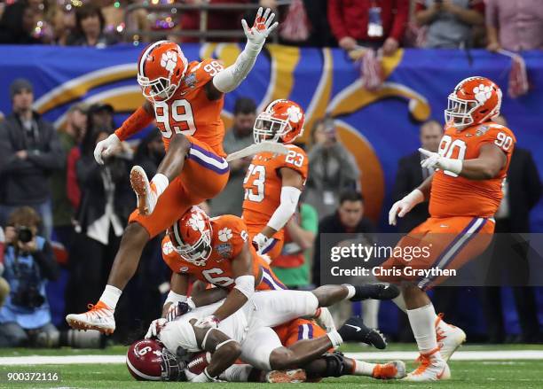 Bo Scarbrough of the Alabama Crimson Tide is tackled by Dorian O'Daniel of the Clemson Tigers in the first quarter of the AllState Sugar Bowl at the...