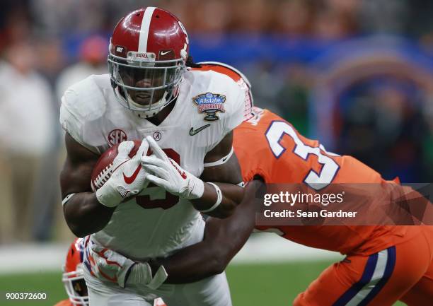 Bo Scarbrough of the Alabama Crimson Tide is tackled by Kendall Joseph of the Clemson Tigers in the first half of the AllState Sugar Bowl at the...