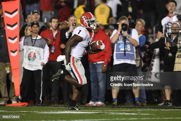 Sony Michel of the Georgia Bulldogs scores on a 27 yard touchdown run in the second overtime of the College Football Playoff Semifinal at the Rose...