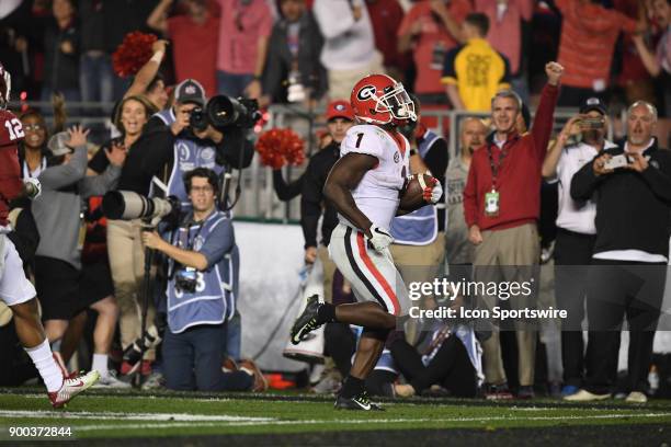 Sony Michel of the Georgia Bulldogs scores on a 27 yard touchdown run in the second overtime of the College Football Playoff Semifinal at the Rose...
