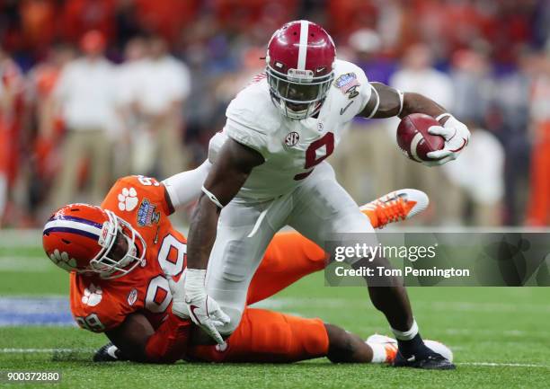 Bo Scarbrough of the Alabama Crimson Tide is tackled by Clelin Ferrell of the Clemson Tigers in the first half of the AllState Sugar Bowl at the...