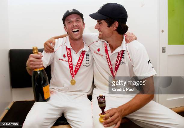 Graeme Swann and Alastair Cook of England celebrate with the Ashes Urn in the changing room following the fifth npower Test Match at the Oval on...