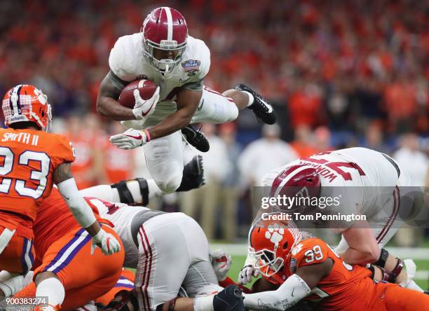 Damien Harris of the Alabama Crimson Tide dives with the ball as Van Smith of the Clemson Tigers defends in the second half of the AllState Sugar...