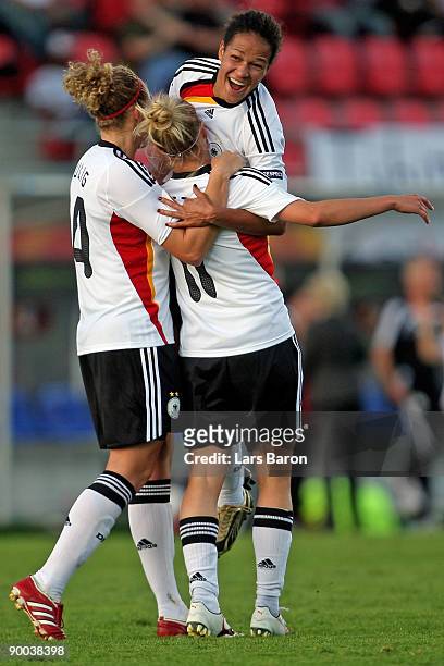 Anja Mittag of Germany celebrates with team mates Kim Kulig and Celia Okoyino da Mbabi after scoring the third goal during the UEFA Women's Euro 2009...
