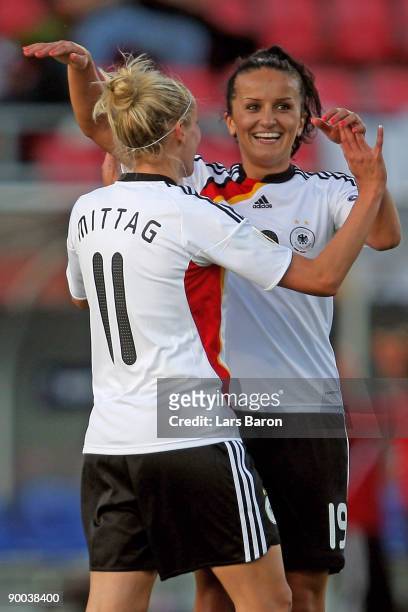 Anja Mittag of Germany celebrates with team mate Fatmire Bajramaj after scoring the third goal during the UEFA Women's Euro 2009 group B preliminary...