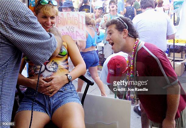 Donna Trenton sits as her chest is airbrushed during a Fantasy Fest October 26, 2001 in Key West, FL. The costume and mask event lasts 10 days.