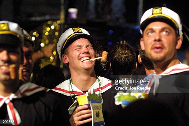 Men dressed as ''Popeye the Sailor Man'' laugh as they participate in a Fantasy Fest October 26, 2001 in Key West, FL. The costume and mask event...